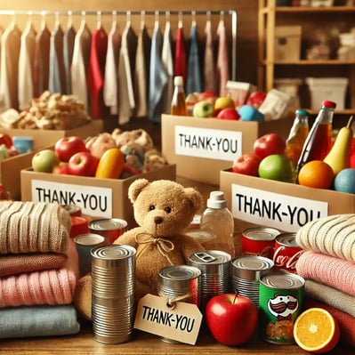 DALL·E 2024-11-12 09.09.44 - A close-up image of a table filled with various donation items for a nonprofit drive. Items include canned food, packaged goods, toys, clothing neatly